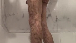 Hot guy cleans himself in the shower.