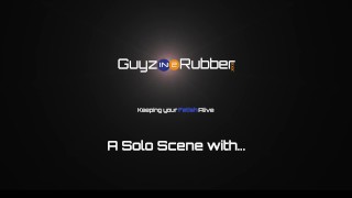 A hot Rubber-clad, booted guy in a biker jacket using a fleshlight on his huge cock to help him cum