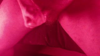 Masturbating with an overhead view with nice red lights