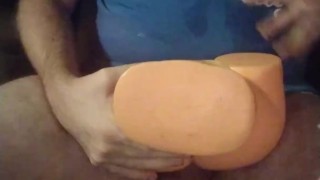 Masturbating with the fake pussy toy