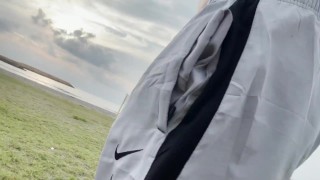 Walking with no shirt and no underwear on the beach
