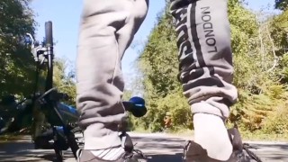 Very daring and very handsome boy plays with his bicycle in public