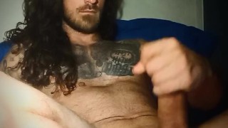 Long hair and tats strokes cock until he cums