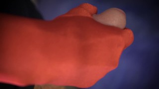 Russian guy masturbates cock with red gloves close up