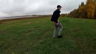 guy jerking off his dick by the lake