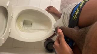 Young black dude pulls down underwear and pisses
