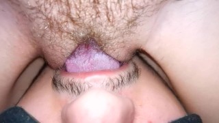 The wife moans from cunnilingus, close-up, sitting on her face with a wet pussy.