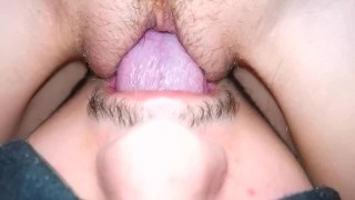 The wife moans from cunnilingus, close-up, sitting on her face with a wet pussy.