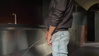 Man pisses in the toilet and plays with his piss