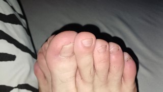 Skinny cute feet fingers stretched out bitten nails