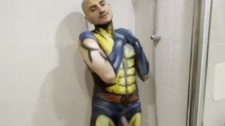 Sexy boy having a hot shower rubbing off body paint