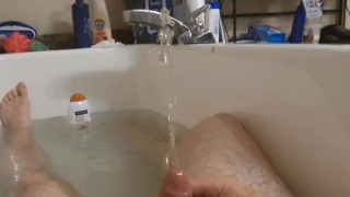 Guy gives himself a golden shower in the bathtub. Hot urine for hot daddy