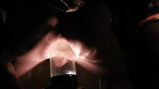 PV TAking Lit Glass Bottle With Head In Back Porch