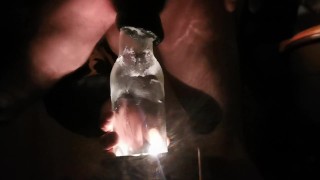 PV TAking Lit Glass Bottle With Head In Back Porch