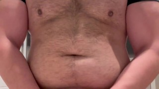 Beefy man in public restroom strips down spits and jerks on thick cock before cumming