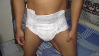 young man urinates his diaper and masturbates