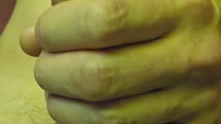A naked man masturbates his penis at home