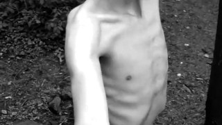 Slender man running around the forest completely naked black and white video