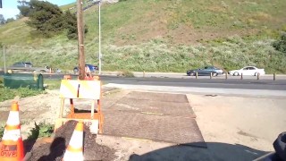 Muscular exhibitionist masturbating in front of traffic
