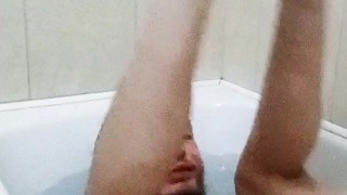 Legs behind the head in a bathtub while touching my cock and showing off feet soles