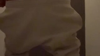 Cheeky guy jerks off a hairy dick in a toilet in sweatpants