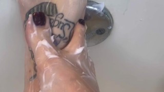 Rubbing tons of lotion and oil over my tattooed feet and huge tits then ride my huge dildo