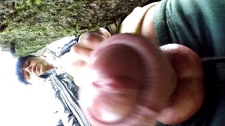 Close up cum behind tree in park and rubbing cum on camera lens with glans