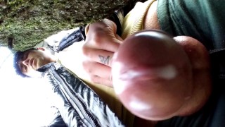 Close up cum behind tree in park and rubbing cum on camera lens with glans