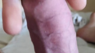 Stretching and squeezing a hard big dick with a small rubber ring. Part 1