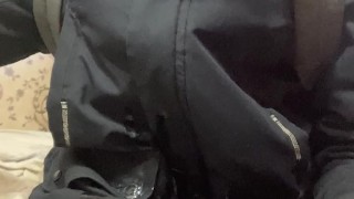 a boy jerks off his dick in a winter jacket and a hat, lighting a lighter and cumming with a fountai