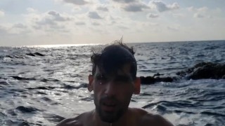 Klaus Joe naked next to a restless sea