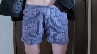 An exhibitionist masturbates while wearing a coat and underpants.