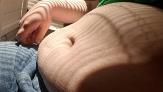 Chubby enby plays with big belly in the sunshine