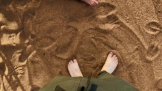 A man pissed on the feet of a guy who was relaxing on a public beach. Pissing in nature