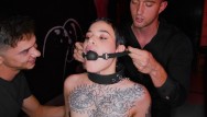 Obedient tattooed slut gets gagged and dominated by two rough guys in BDSM style