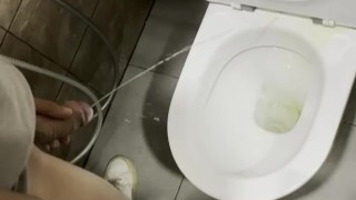 pissing hard at a public bathroom