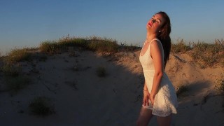 This horny bitch strips naked, touches her vagina in the dunes and then fingers herself