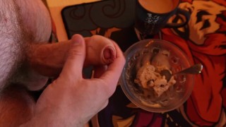 A guy jerks off his hairy dick and cums a lot into the ice cream he feeds his friend. Cum in food