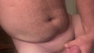 Stocky Bear stokes and plays with his thick cock