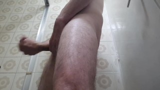 Man with sexy hot body jerking off his big dick in the bathroom