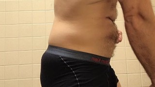 Hairy muscle bear flexing and posing after gym workout