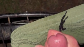 Cumming in park on bike and short