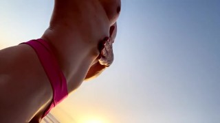Mommy stroking her big uncut cock on the beach in front of admirers