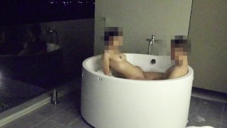 Asian couple having sex in an outdoor jacuzzi, someone is peeking.