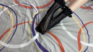 Caressing long legs of girl in black lace socks