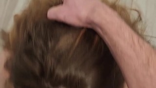 Curvy redhead gets on her knees and swallows for the first time