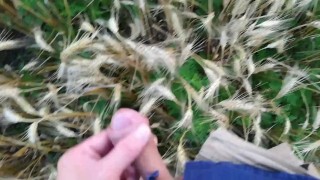 Farmer shows his dirty rubber boots and pee huge in the wheat field