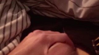 Playing with thick mushroom-headed cock in a tight condom