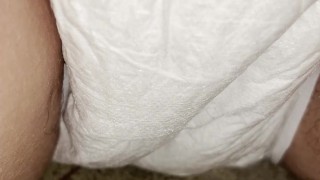 Babe wets her diaper outside while it becomes drenched in piss