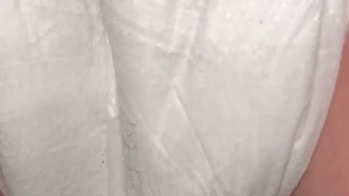 Girl pisses in diaper close up from behind